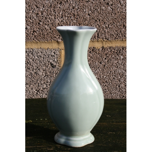 381 - A Chinese pale celadon glazed vase with blue seal mark to the underside, 20cms (8ins) high.