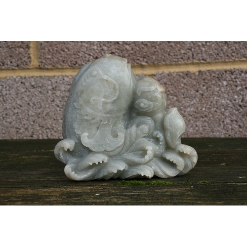 504 - A Chinese jade / hardstone boulder carved in the form of a stylised fish, 14cms (5.5ins) high.