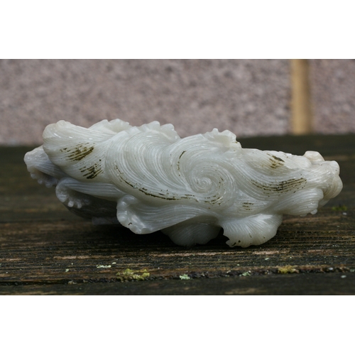 504 - A Chinese jade / hardstone boulder carved in the form of a stylised fish, 14cms (5.5ins) high.