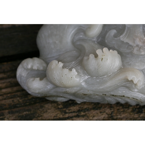 504 - A Chinese jade / hardstone boulder carved in the form of a stylised fish, 14cms (5.5ins) high.