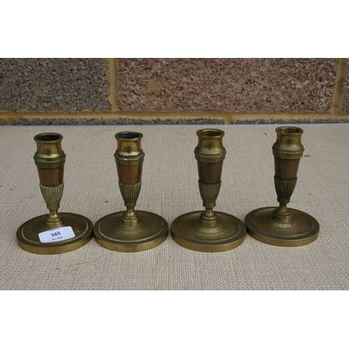 565 - A set of four Regency candlesticks. 13cm (5 ins) high