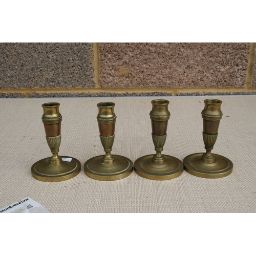 565 - A set of four Regency candlesticks. 13cm (5 ins) high