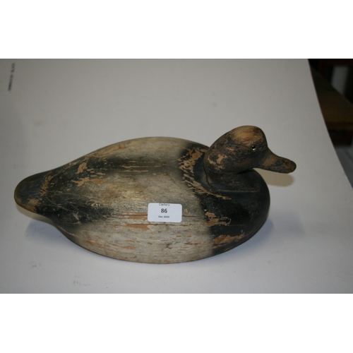 86 - A wooden and painted decoy duck, 26cms (10ins) wide.