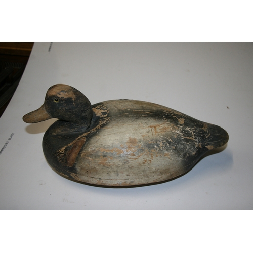 86 - A wooden and painted decoy duck, 26cms (10ins) wide.