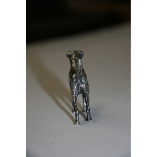 174 - A novelty silver pepper caster in the form of a standing hound, maker's mark for William Comyns & So... 