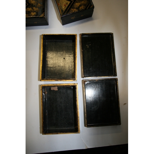 369 - A set of Japanese lacquered boxes with gilt decoration on a black ground (5).