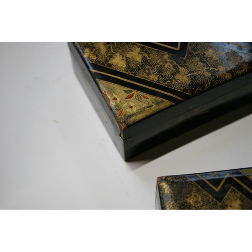 369 - A set of Japanese lacquered boxes with gilt decoration on a black ground (5).