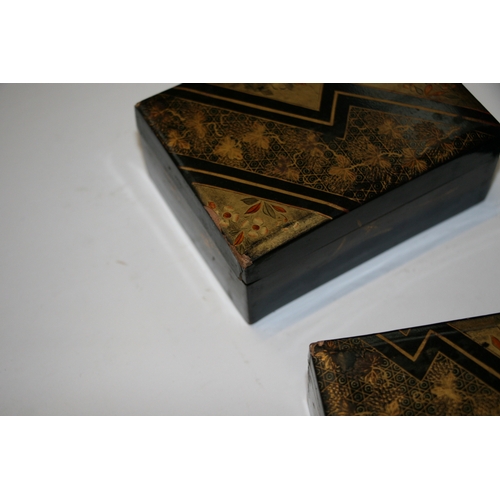 369 - A set of Japanese lacquered boxes with gilt decoration on a black ground (5).