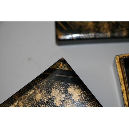 369 - A set of Japanese lacquered boxes with gilt decoration on a black ground (5).