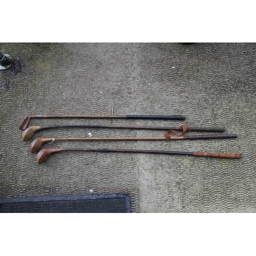 875 - A quantity of hickory shafted golf clubs.