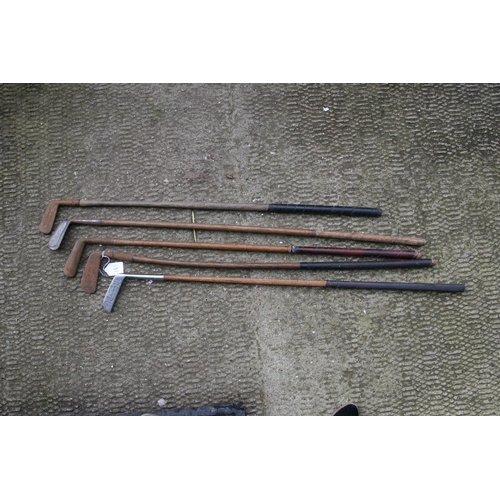 875 - A quantity of hickory shafted golf clubs.