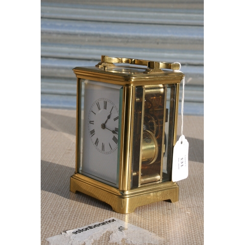 131 - A brass cased repeater carriage clock, the white enamel dial with Roman numerals, the movement strik... 