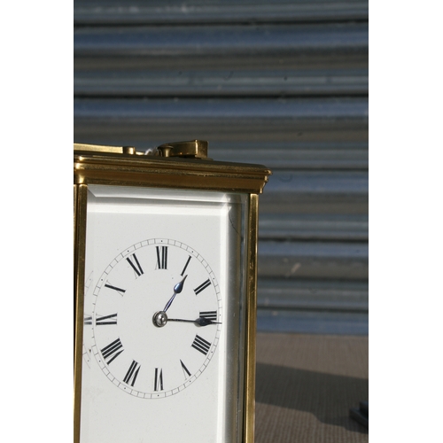 131 - A brass cased repeater carriage clock, the white enamel dial with Roman numerals, the movement strik... 