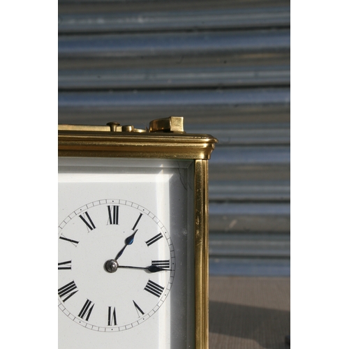 131 - A brass cased repeater carriage clock, the white enamel dial with Roman numerals, the movement strik... 