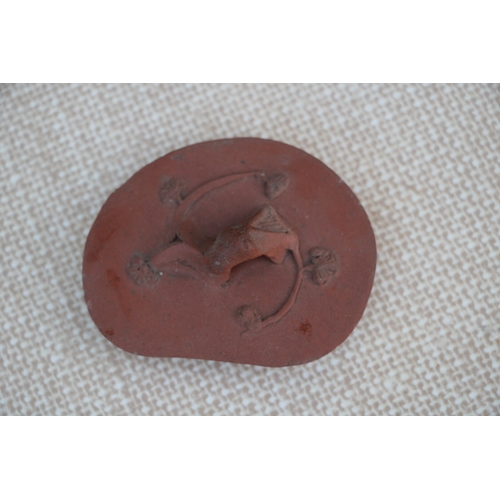 403 - A Chinese Yixing pottery teapot decorated with prunus, impressed seal mark to the underside, 9cm (3.... 