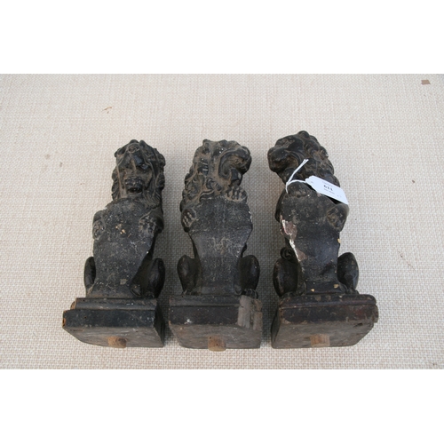 611 - Three late 18th century carved oak rampant lions holding shields, each approx 23cms (9ins) high (3).