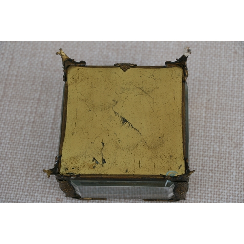 625 - A Victorian gilt metal and glass jewellery casket, 11 by 11 by 9cm (4.25 by 4.25 by 3.5 ins).