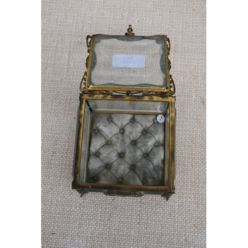 625 - A Victorian gilt metal and glass jewellery casket, 11 by 11 by 9cm (4.25 by 4.25 by 3.5 ins).