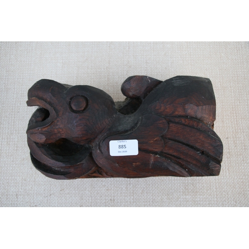 885 - A Native American style oak carving in the form of a stylised eagle. 28cm (11 ins) wide