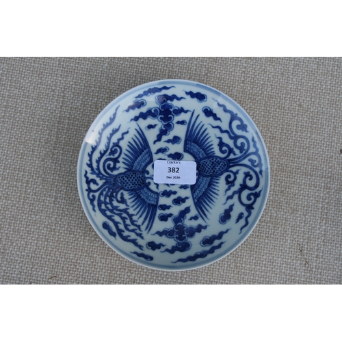 382 - A Chinese blue & white shallow dish decorated with a phoenix amongst clouds, six character blue mark... 