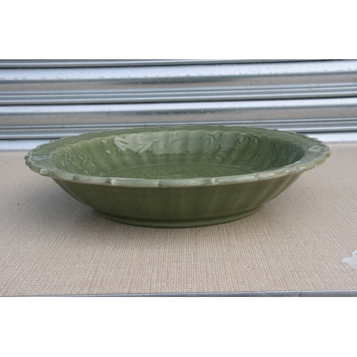 482 - A large Chinese celadon glaze shallow bowl with incised decoration, 40cms (15.75ins) diameter.