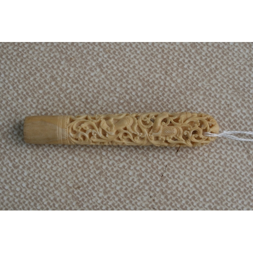 396 - A Burmese carved and pierced ivory handle, 11cms (4.25ins) long.