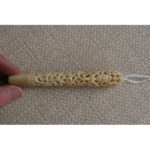 396 - A Burmese carved and pierced ivory handle, 11cms (4.25ins) long.