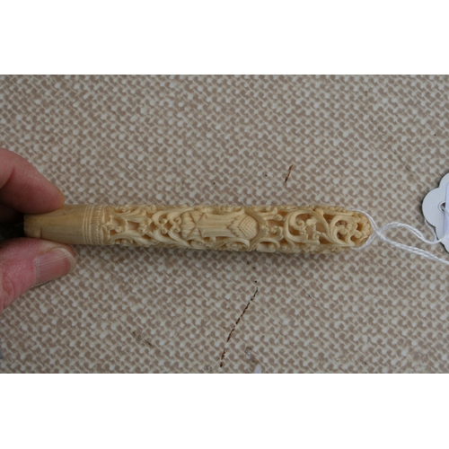 396 - A Burmese carved and pierced ivory handle, 11cms (4.25ins) long.