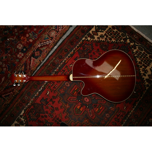 92 - A Manito semi acoustic guitar with two Humbucker pick ups and Sunburst finish, with soft carrying ca... 