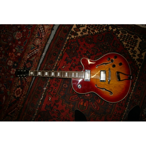 92 - A Manito semi acoustic guitar with two Humbucker pick ups and Sunburst finish, with soft carrying ca... 