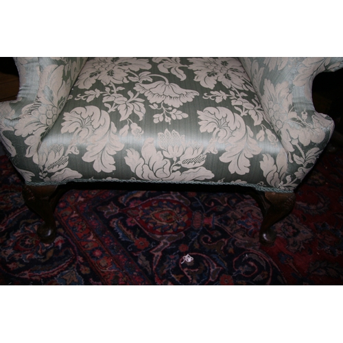 767 - An 18th century style upholstered wing back armchair on shell capped dwarf cabriole legs, with pad f... 