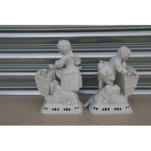 49 - A pair of Meissen style blanc de chine figural groups in the form of a young boy and girl with baske... 