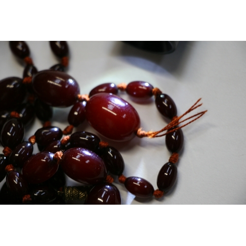 229 - A quantity of cherry amber bead necklaces to include four long necklaces, four faceted cherry amber ... 