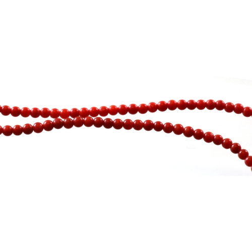 1014 - A coral bead necklace with 18ct gold clasp, 42cm (16.5 ins) long.