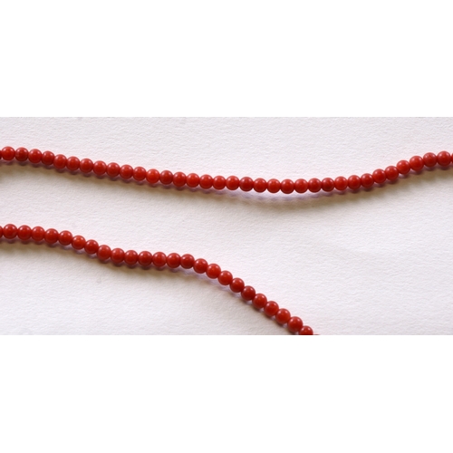 1014 - A coral bead necklace with 18ct gold clasp, 42cm (16.5 ins) long.