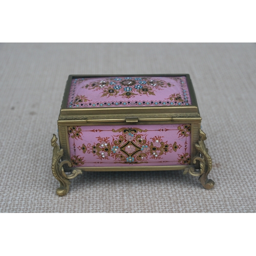 603 - A 19th century French enamel trinket box in the manner of Tahan of Paris, the pink ground with appli... 