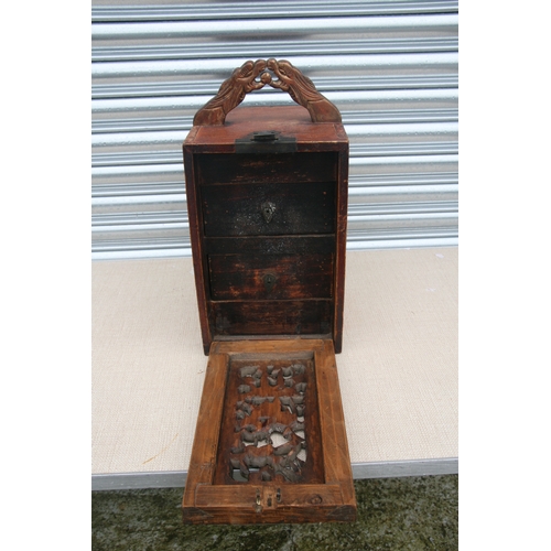 538 - A Chinese carved wooden table top cabinet with a carved and pierced fall front revealing a fitted in... 