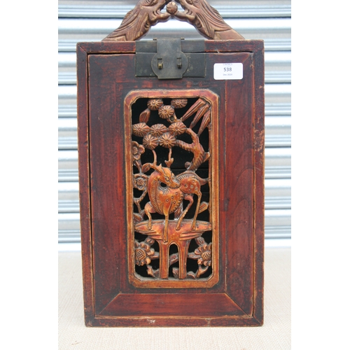 538 - A Chinese carved wooden table top cabinet with a carved and pierced fall front revealing a fitted in... 