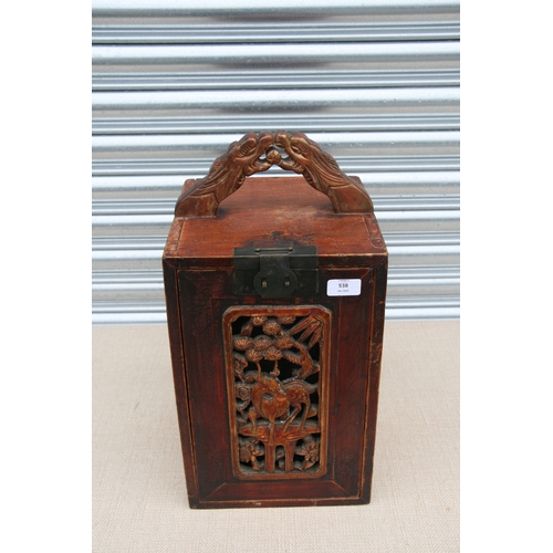 538 - A Chinese carved wooden table top cabinet with a carved and pierced fall front revealing a fitted in... 