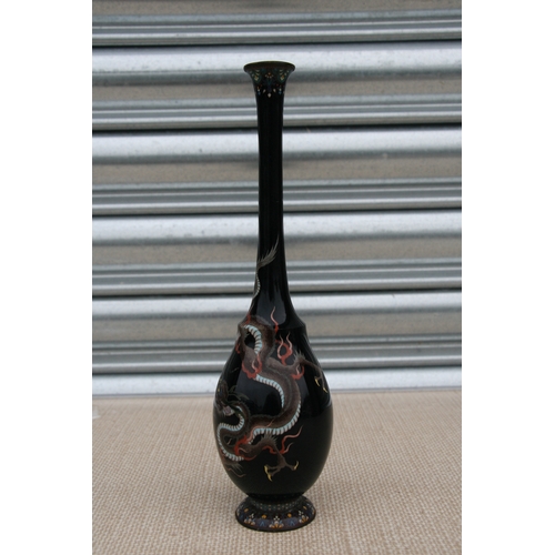 544 - A Japanese cloisonne vase of slender baluster form, decorated with a silver wire dragon on a black g... 