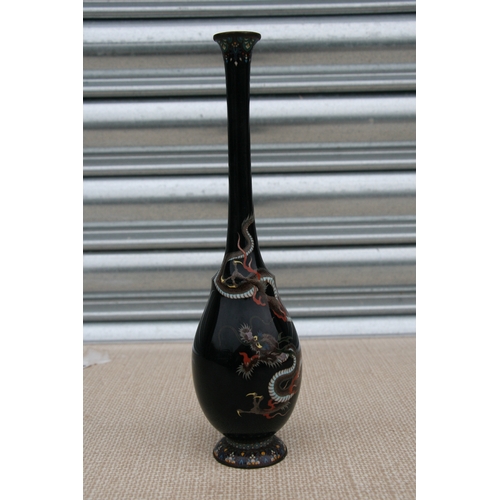 544 - A Japanese cloisonne vase of slender baluster form, decorated with a silver wire dragon on a black g... 