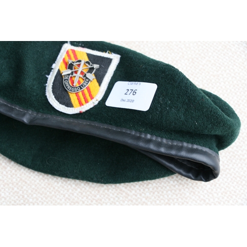 276 - Two Vietnam war period berets and cloth badges, to include Special Forces.