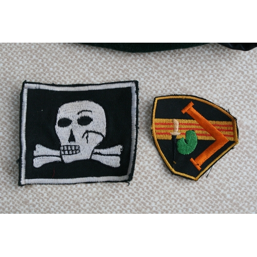 276 - Two Vietnam war period berets and cloth badges, to include Special Forces.