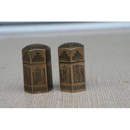 156 - A Persian silver salt and pepper of hexagonal form decorated with stylised figures, 5cms (2ins) high... 