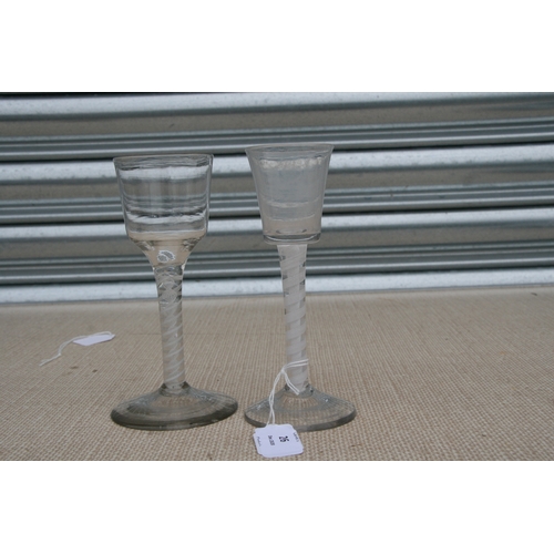 26 - An 18th / 19th century air twist wine glass with double helix to the stem, 16cms (6.25ins) high; tog... 