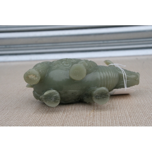 494 - A Chinese jade / hardstone carving in the form of a rhinoceros, 18cms (7ins) long.