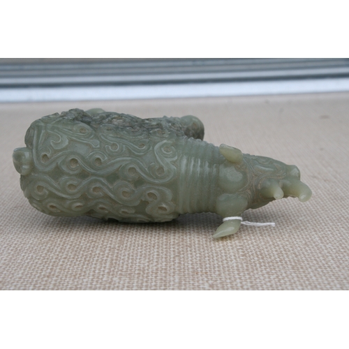 494 - A Chinese jade / hardstone carving in the form of a rhinoceros, 18cms (7ins) long.