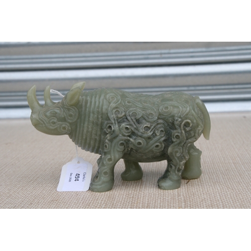 494 - A Chinese jade / hardstone carving in the form of a rhinoceros, 18cms (7ins) long.