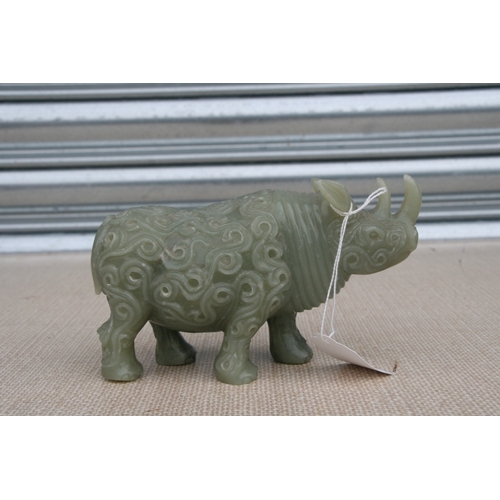 494 - A Chinese jade / hardstone carving in the form of a rhinoceros, 18cms (7ins) long.