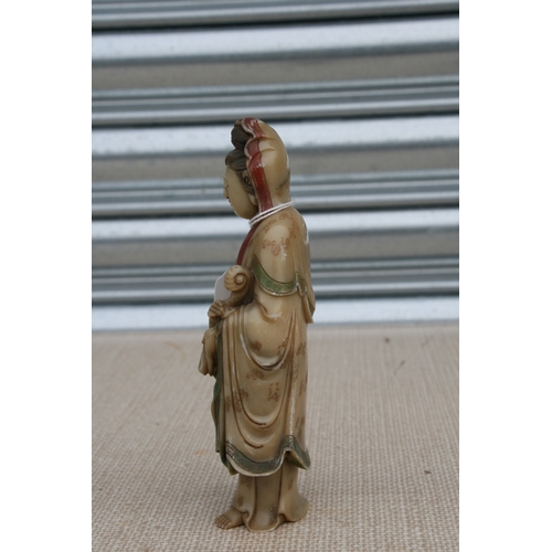 532 - An 18th / 19th century Chinese polychrome soapstone carving depicting Guanyin, 17cms (6.75ins) high.